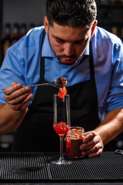 Professional bartender preparing cocktails at an event bar