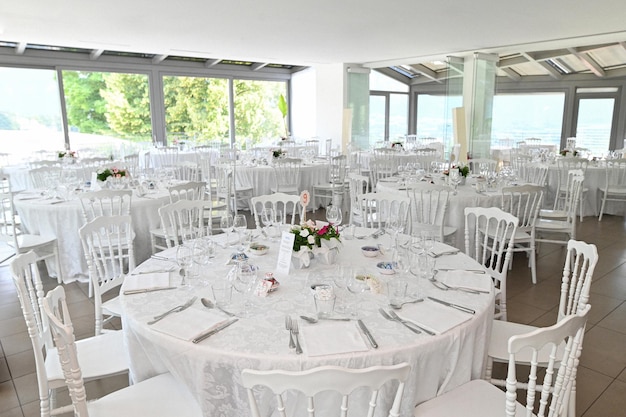 Elegant event venue with white chairs and table settings